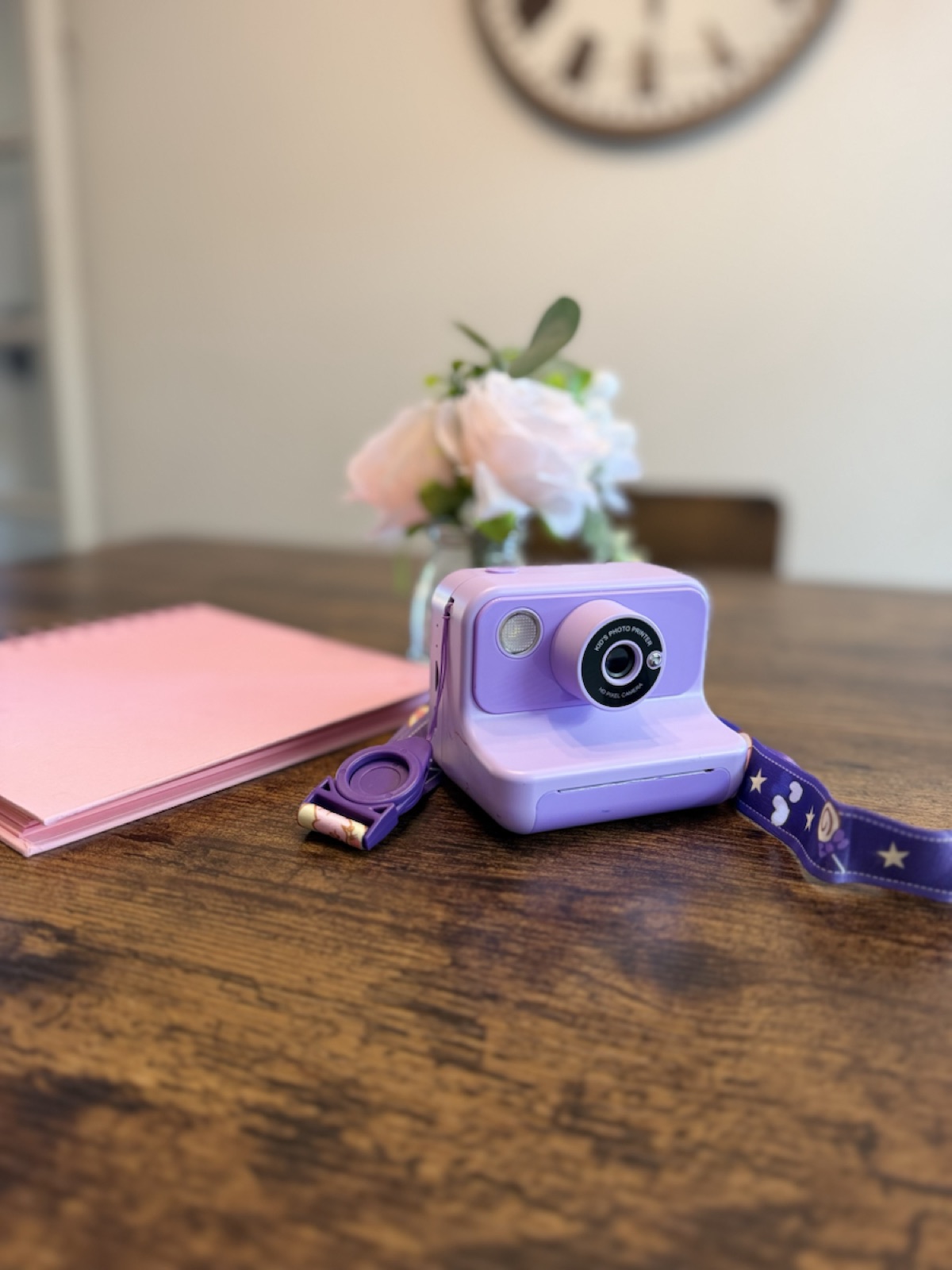 Purple GoFunly instant-print camera styled on a table